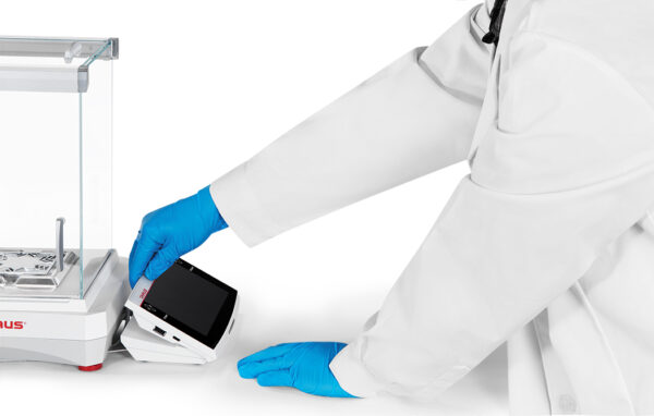 Ohaus Explorer, 2025 model, Semi-Micro Balance, Plus EXP, viewed from the side with person adjusting the terminal angle. White background