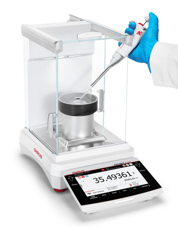 Explorer 2025 model, Semi-Micro Balance, Plus EXP, with pipette calibration chamber in situ, balance turned on and being used, viewed side on, white background.