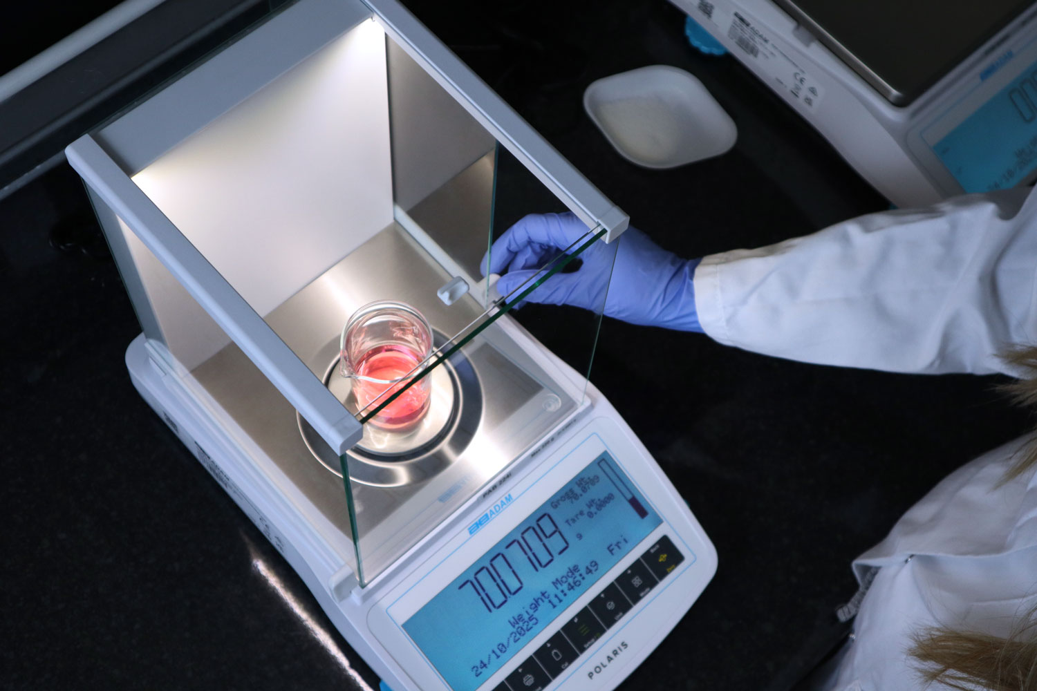 PAB4-Cylinder-inside2 (3) Analytical Balance being used by operator.